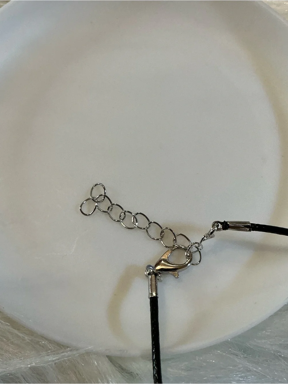 Pretty blue/silver-tone cross/religious pendant black string necklace